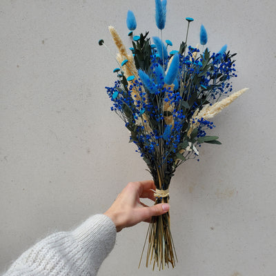 Bouquet de fleurs stabilisées éternelles bleu composé d'amarante gypsophile lagurus botao eucalyptus parvifolia. Vue de côté